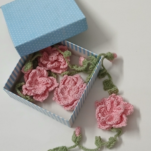 Crochet handmade hair crown with floral design worn in braided hairstyle